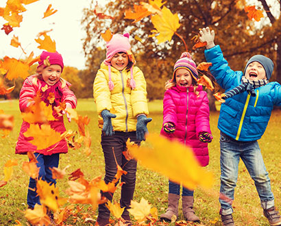  Children throw autumn leaves